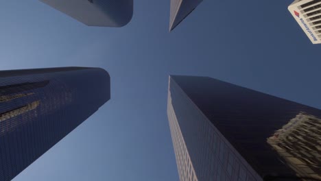 looking-up-moving-shot-of-modern-skyscrapers-in-downtown-Los-Angeles,-on-a-sunny-day-in-California