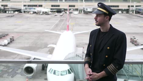 Young-airplane-captain-standing-on-airport