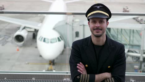 Good-looking-pilot-with-airplane-and-airport-background