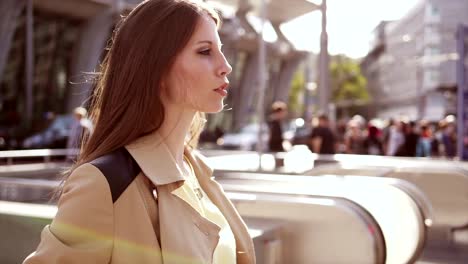 Young-adult-woman-enjoying-her-day-in-the-city-and-at-the-train-station