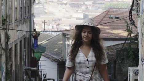 Lady-in-hat-drinking-from-cup-and-walking-on-street