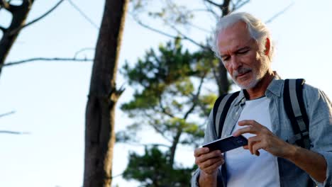 Senior-hombre-clic-en-fotos-con-el-teléfono-móvil-en-el-campo-4k