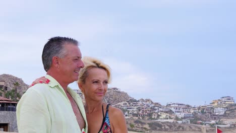 Portrait-of-an-older-couple-standing-on-the-beach