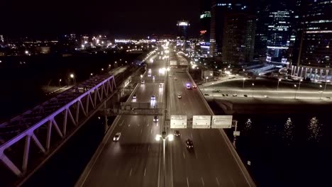 Aerial-night-highway-bridge-passing-cars