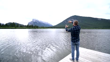 One-young-man-framing-mountain-landscape-with-hands