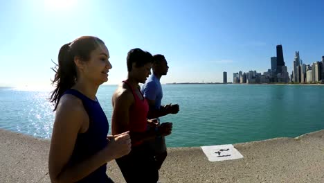 Fit-Multi-Ethnic-American-friends-running-in-city