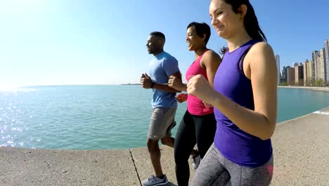 Ethnic-male-and-females-running-in-Chicago-city