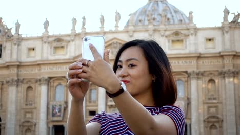 pretty--Chinese-tourist-taking-selfie-in-San-Pietro-Square,-Rome