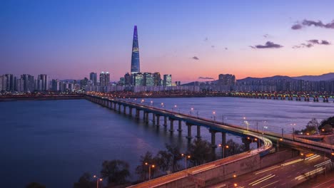 Time-lapse-video-of-Han-River-at-night-with-view-of-Seoul-city-skyline-in-South-Korea,-timelapse