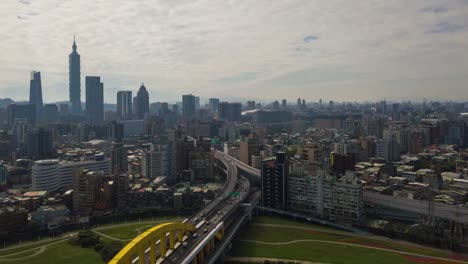 sunny-day-taipei-cityscape-river-traffic-bridge-aerial-downtown-panorama-4k-timelapse-taiwan