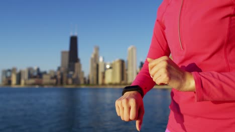 Mujer-al-aire-libre-ajuste-de-reloj-de-pulsera-inteligente-caucásico-hispano