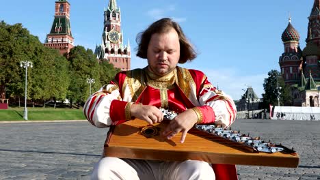 Folk-performer-with-music-instrument-gusli