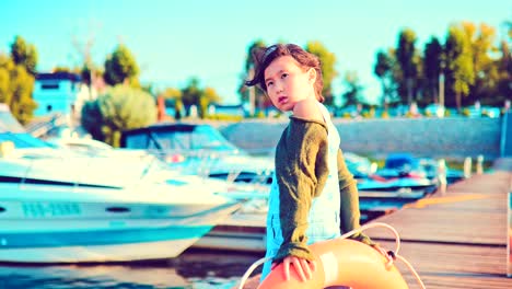 Girl-with-a-life-buoy-on-a-yacht-pier