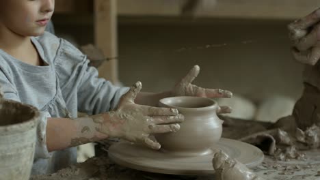 Little-Girl-Throwing-Pot-in-Pottery-Class