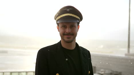 Good-looking-pilot-with-airplane-and-airport-background