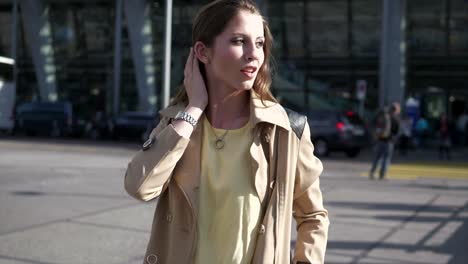 Young-adult-woman-enjoying-her-day-in-the-city-and-at-the-train-station