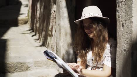 Woman-sitting-on-the-threshold-portuguese-building