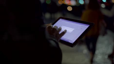 Handsome-man-teleworking-on-digital-tablet-at-night