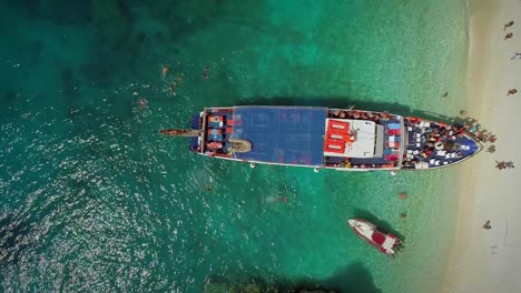 Aerial-view-of-people-disembarking-off-ferry,-Ithaki-island,-Greece.