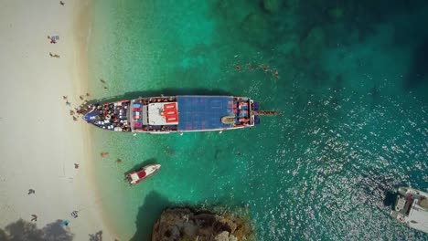 Aerial-view-of-people-disembarking-off-ferry,-Ithaki-island,-Greece.