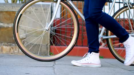 Woman-walking-with-bicycle-in-city-street-4k