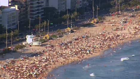 Aerail-view-of-crowded-Ipanema-Beach,-Rio-de-Janeiro,-Brazil