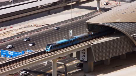 Locked-On-shot-of-subway-train-moving-on-bridge,-Dubai,-United-Arab-Emirates