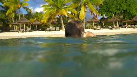 Boy-diving-and-making-photos-with-waterproof-camera