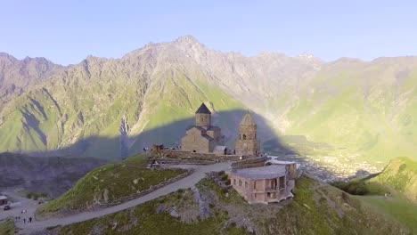 aerial.-Gergeti-orthodox-church-high-in-the-mountains,-Georgia