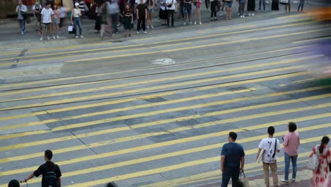 Crowd-of-people-walking-crossing-street-at-a-busy-intersection-in-Hong-Kong,