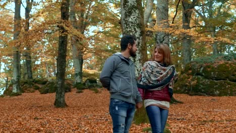 Romantic-smiling-couple-in-the-forest-in-fall-season