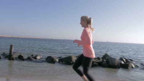 woman-jogging-along-the-sea-coast