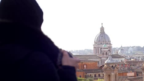 Standing-woman-contemplating-Saint-Peter-in-Rome.-Religion,hope,faith-backview