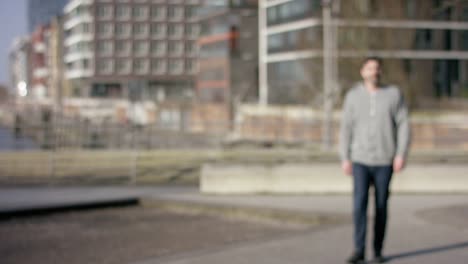 Middle-aged-man-walking-into-focus-in-urban-city