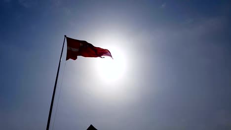 Denmark-flag-waving-in-sky-under-sunrays,-national-symbol,-patriotism-emblem