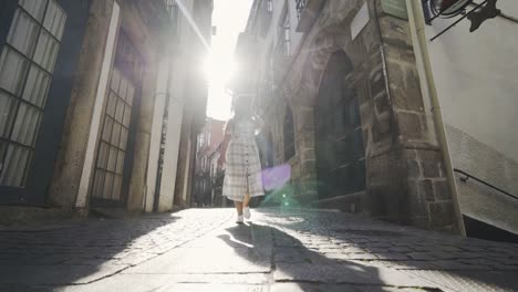 Woman-walking-on-typical-portuguese-street