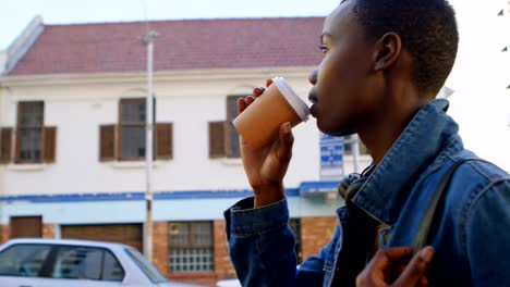 Woman-having-coffee-while-walking-in-city-street-4k