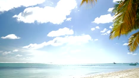 Tropical-resort-and-empty-deck-chair-by-ocean