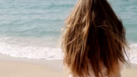 Girl-with-long-ginger-red-hair-enjoying-seascape.-Sea-breeze-playing-with-hair.