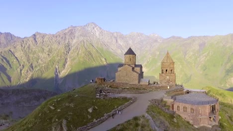 aerial.-Gergeti-orthodox-church-high-in-the-mountains,-Georgia