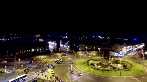 Spanish-Square-aerial-view-in-Barcelona,-This-is-the-famous-place-with-traffic-light-trails,-fountain-and-Venetian-towers,-and-National-museum-at-the-background.-Blue-sky