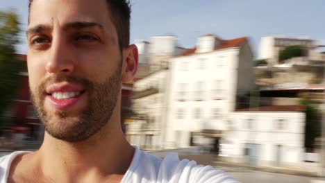 Man-taking-a-selfie-in-Lisbon,-Portugal