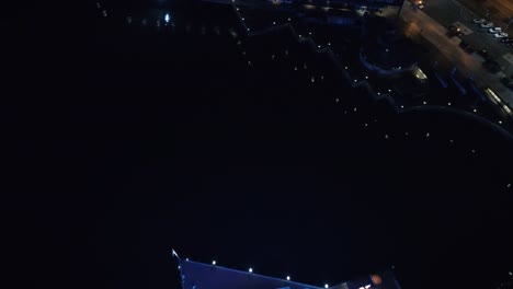 Helicopter-View-Passing-Over-Bright-Ferris-Wheel-at-Night