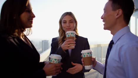 Multi-ethnic-business-managers-enjoying-coffee-on-rooftop