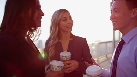 Multi-ethnic-business-managers-drinking-coffee-on-rooftop