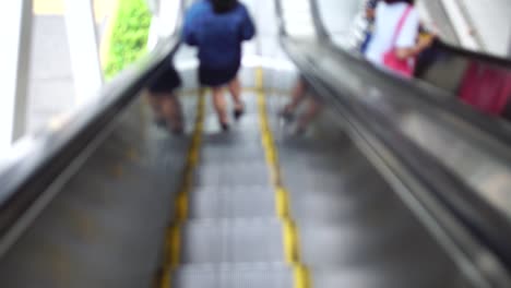 Travelers-passengers-in-airport-transit-terminal-walking-with-luggage-baggage-going-traveling.-Business-travel-people-out-of-focus-and-blurry-in-background-:-4k