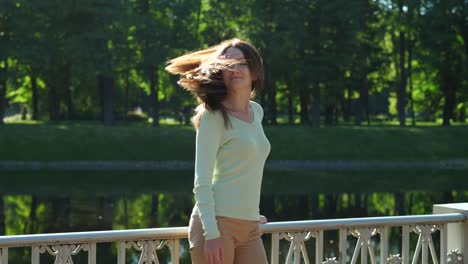 Woman-flip-her-long-golden-hair,-sun-shine-through,-slow-motion