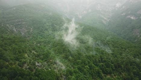 Dark-foggy-rainy-clouds-above-the-mountain-europe-village-house-in-the-forest