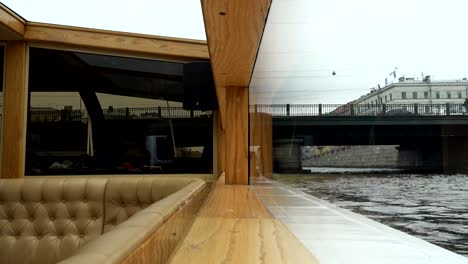 boat-sailing-with-tourists-under-the-bridge