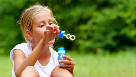 Little-girl-playing-with-soap-bubbles-outdoor.-Slow-motion.